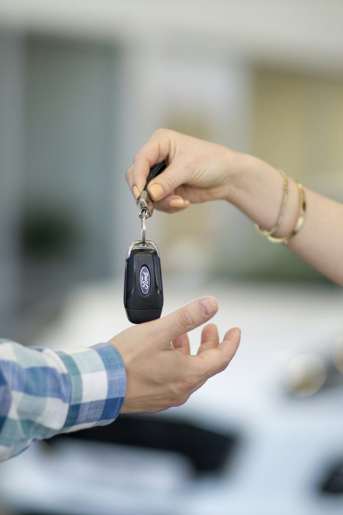 Handing over car keys after a sale